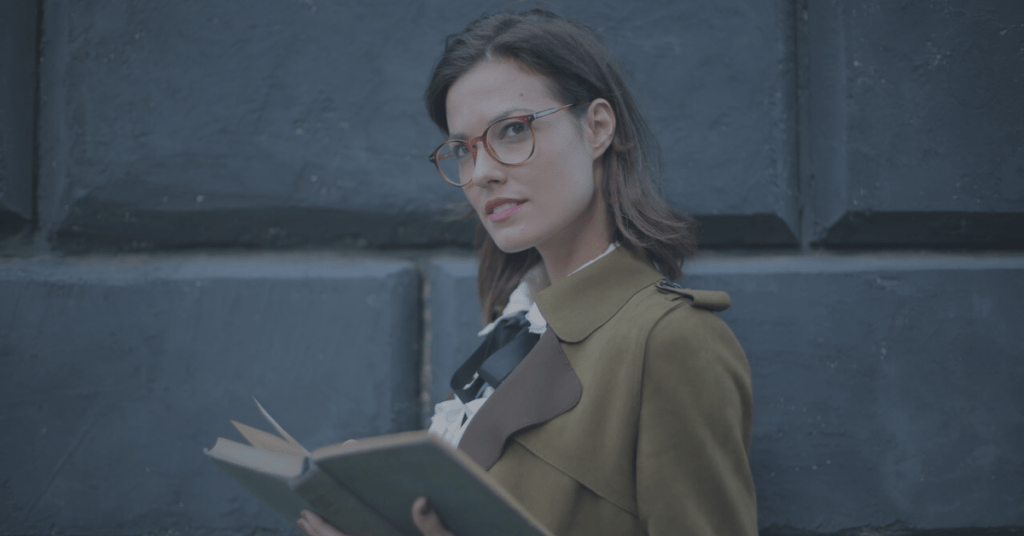 Woman wearing glasses with a book in her hands
